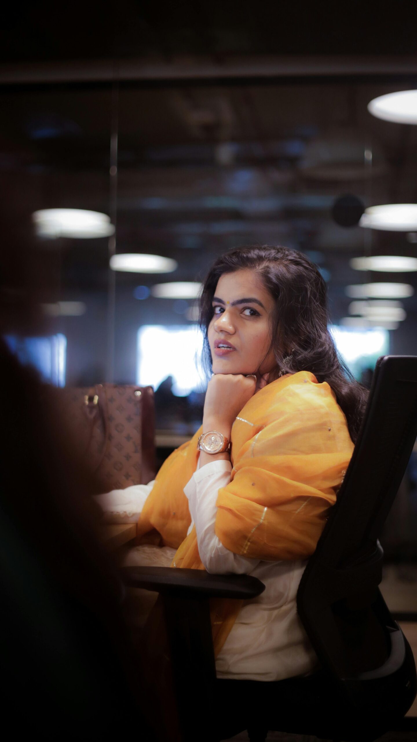 indian office girl looks at the camera with cute expression